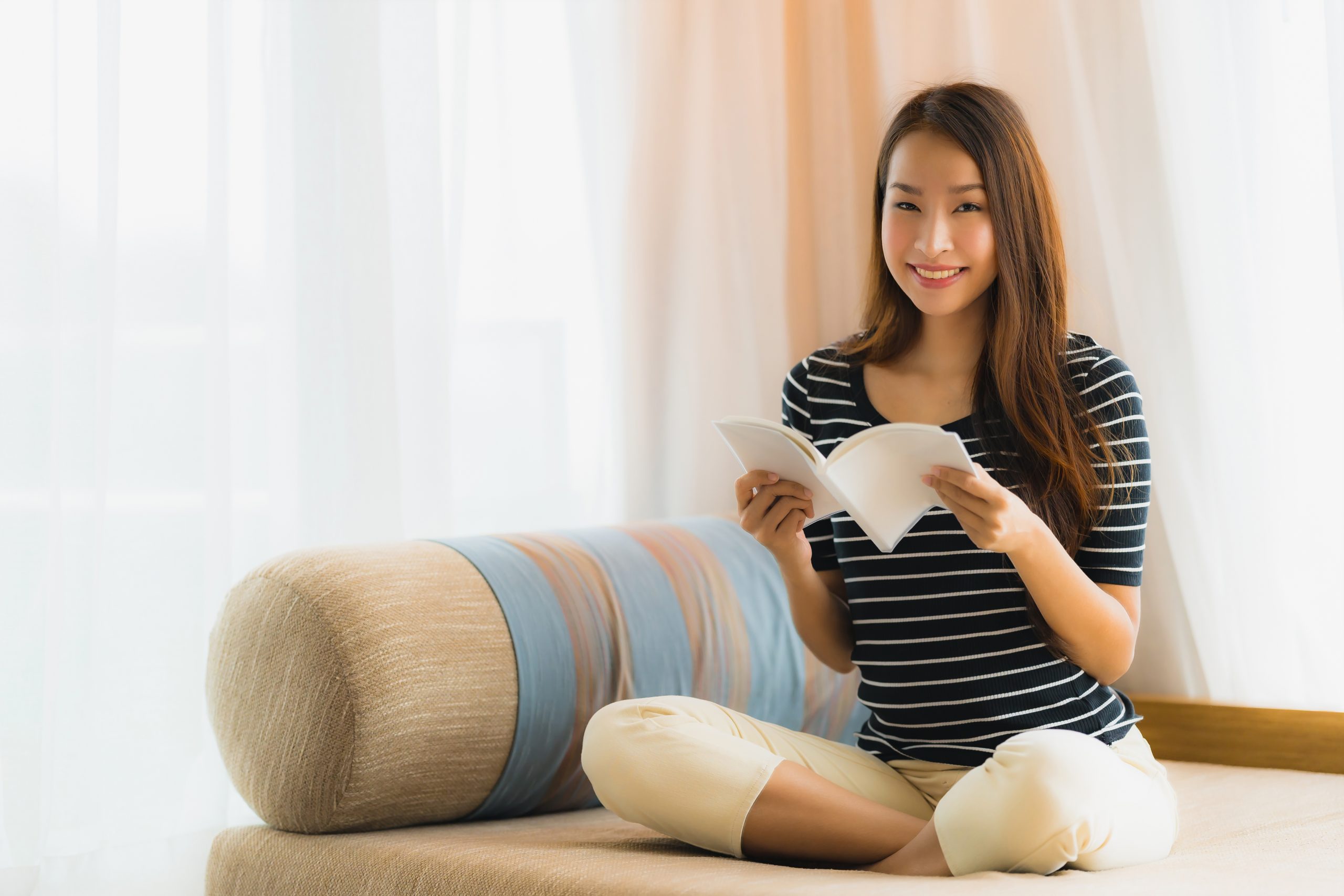 portrait beautiful young asian woman reading book sofa living room area scaled