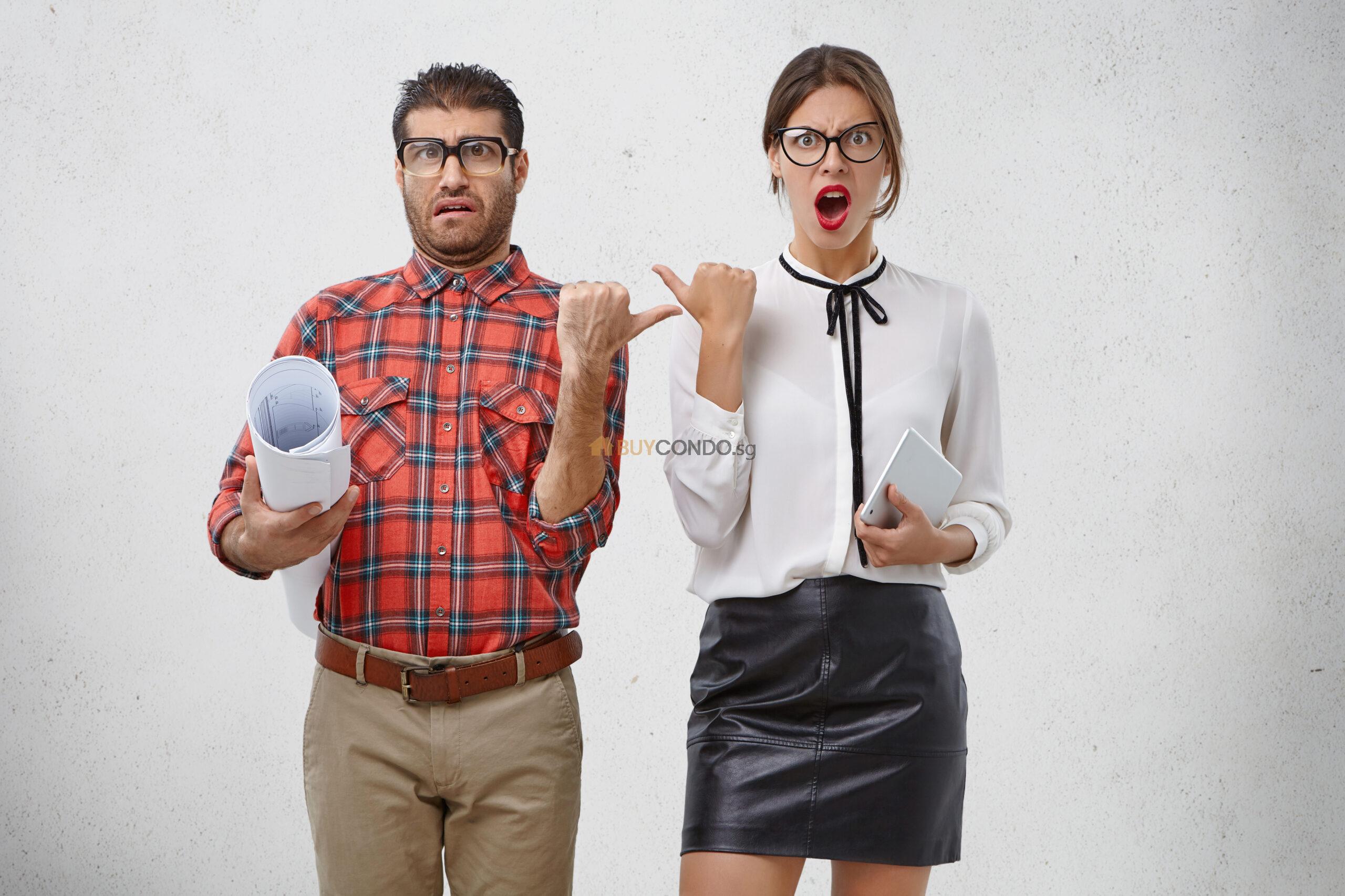 emotional female male coworkers point each other with dissatisfaction scaled