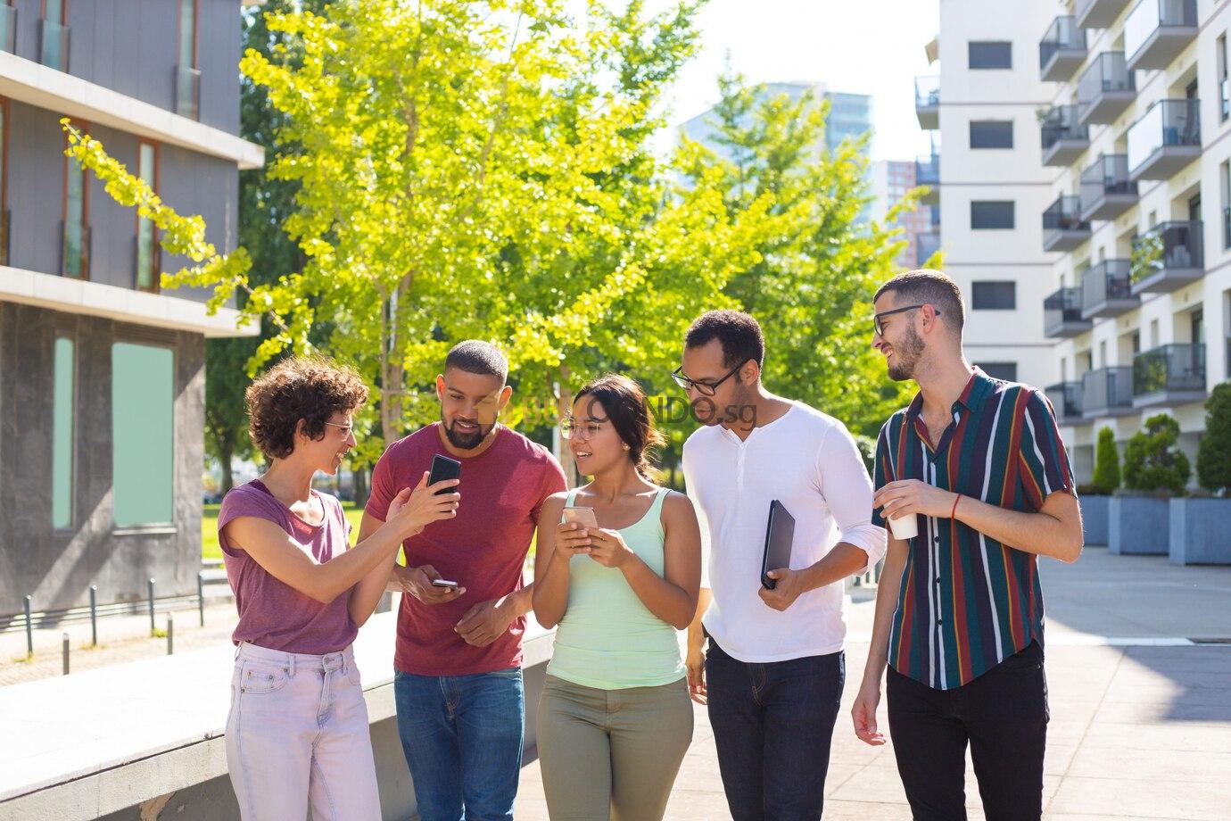 cheerful woman showing phone screen her excited peers 1262 20865